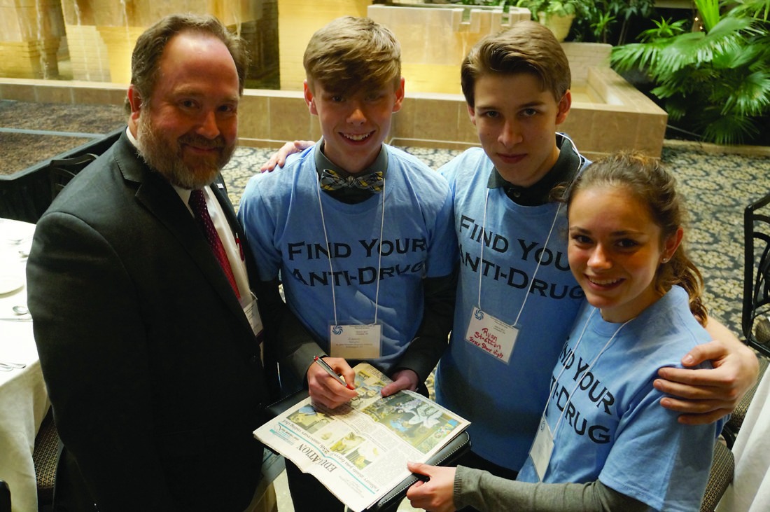 High school students talk with the President of American Public Health Association Tom Quade. They are, from left, Connery McFadden, Ryan Stratton and Mary McMahon.