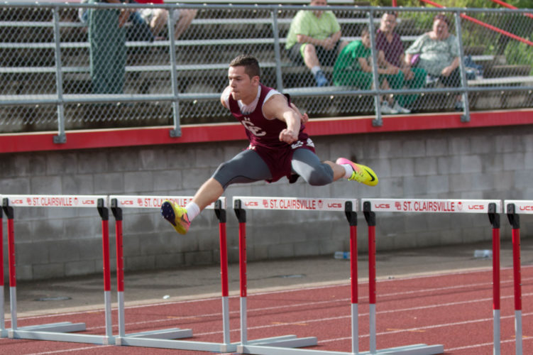 Photo by Sheri McAninch / Wheeling Central’s John Burkhalter competes in the 100 hurdles during the first day of the OVAC Championships on Monday at St. Clairsville.