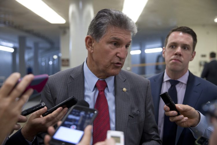 FILE- In this June 20, 2016, file photo, Sen. Joe Manchin, D-W.Va., talks with reporters on Capitol Hill in Washington. Manchin remained mum Wednesday as a pharmaceutical company run by his daughter faced mounting criticism for hiking prices on life-saving allergy injection pens. (AP Photo/Alex Brandon, File)