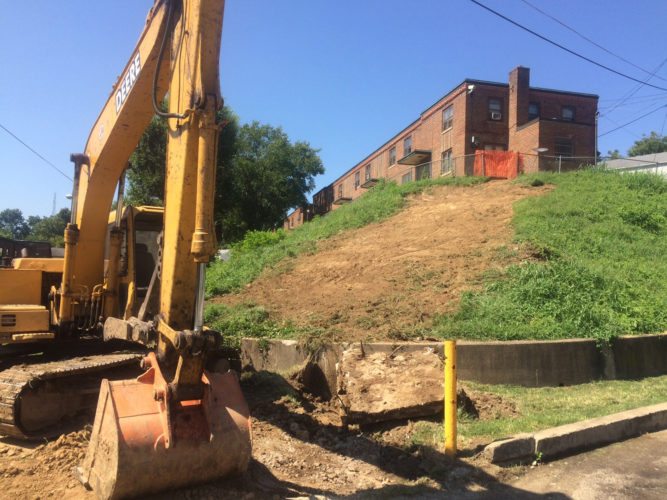 This Aug. 28, 2016 photo shows the Marcum Terrace public housing complex in Huntington, W.Va. Weeks after a string of overdoses, the city tore down a set of concrete stairs at the entrance to the complex. Drug dealers often hung out on the stairs that stretched up a hill overlooking the community center where children gather for after-school activities. They acknowledge the dealers will likely just move elsewhere, but see the demolition as a symbolic message that the city is fighting against the heroin epidemic. (AP Photo/Claire Galofaro)