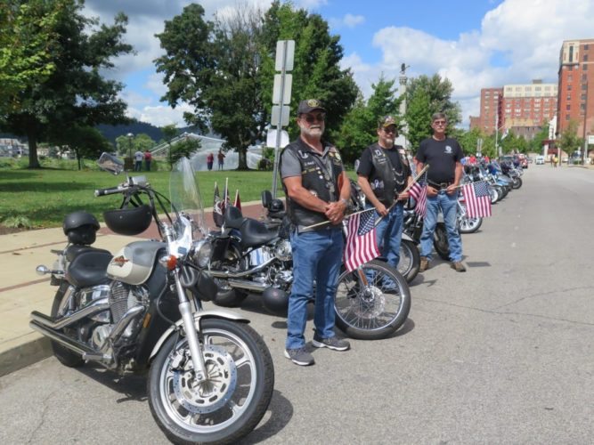 TRIBUTE -- A line of motorcycles and members of the Patriot Guard Riders welcome those attending the Ohio Valley 9-11 Memorial event Sunday at WesBanco Arena. Pictured, from left, are Dick Johnson and John Johnson of Bellaire, both members of the Ohio Valley Chapter of the American Legion Riders, Bellaire Post 52; and Grover Brogan of Valley Grove, a member of the Elm Grove Eagle riders. -- Joselyn King 